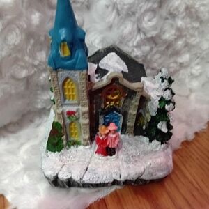 Charming Holiday Village with Blue Roof and Snow Accents